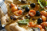 Pizza: anchovies with truffle, cherry tomatoes and basil